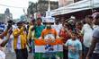 A man is seen covered in body color representing Trinamool Congress party with various ins...