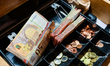 Bills and coins in a cash register. Illustration pictures of bills and coins in euro. Cour...