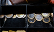 Coins of 1 and 2 euros in a cash register. Illustration pictures of bills and coins in eur...