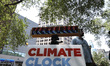 Demonstrators rally with signs near the Climate Clock in Union Square on July, 22, 2022 in...
