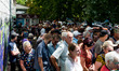 Civilians are seen queuing for the food at the local distribution point in Mykolaiv, Ukrai...