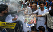 Protestors are seen lighting a effigy of Ex-Education Minister of West Bengal Partha Chatt...