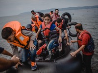 Migrants rush off the dinghy they cross the sea with once they arrive in Lesbos, Greece, Greece, on September 26, 2015.  (