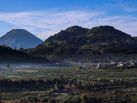 Mountain scenery and hills planted with vegetables are seen in the Dieng mountain area in Banjarnegara, Central Java province, Indonesia, on...