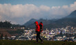 A tourist enjoys a view of the Dieng mountain area in Banjarnegara, Central Java province,...