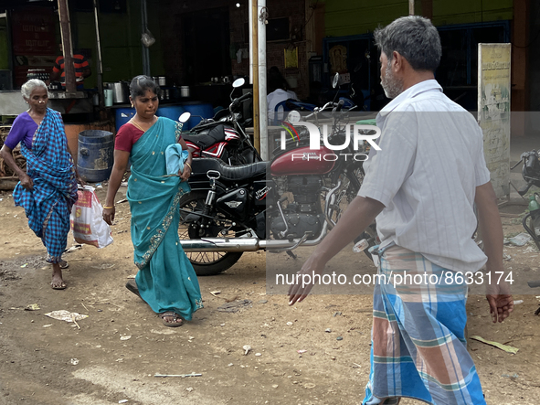 People walk past shops in the town of Nilakkottai (Nilakottai), Tamil Nadu, India, on May 18, 2022. 