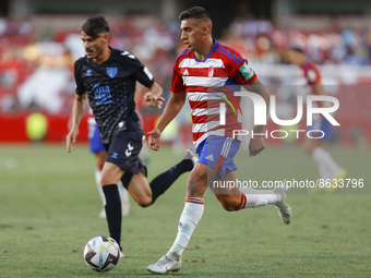 Myrto Uzuni, of Granada CF  and Jozabed Sanchez, of Malaga CF during the City of Granada Trophy match between Granada CF and Malaga CF at Nu...