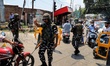 Paramilitary forces stop people at a temporary check point ahead of Muharram Processions i...