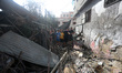 Men inspect damage to a house affected by nearby bombardment in an Israeli air strike at t...