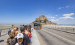 Lines of tourists and visitors waiting to board the bus towards the parking or arriving an...