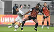Jonathan Kodjia (22) of Umm Salal and Guilherme Torres (18) of Al Sadd battle for the ball...
