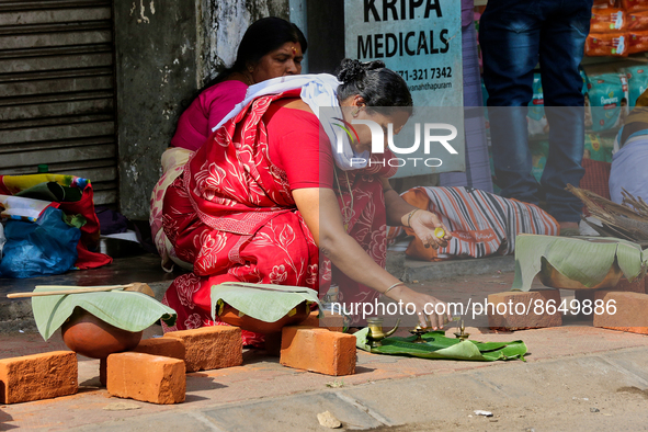 Hindu women finish final preparations before cooking pongala along the roadside on the morning of the final day of the 10 day-long Attukal P...