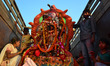  Indian Hindu devotees carry an idol of the goddess Durga to be immersed in a temporary po...