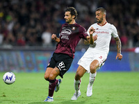 Antonio Candreva of US Salernitana 1919 and Leonardo Spinazzola of AS Roma compete for the ball during the Serie A match between US Salernit...