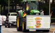 a tractor with sign of " without us your plate would be empty " is seen arriving during hu...