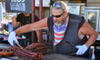 Barbecuer cooks racks of ribs during the Northern Heat Rib and Beer Festival in Richmond H...