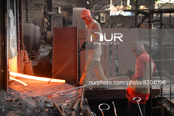 Laborers during work at a metal workshop at Postogola Area in Dhaka, Bangladesh on August 22, 2022.  