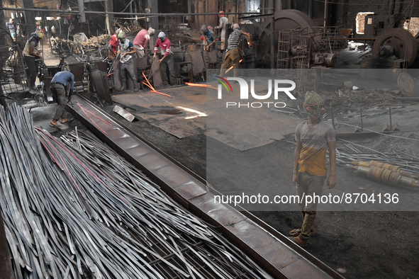 Laborers during work at a metal workshop at Postogola Area in Dhaka, Bangladesh on August 22, 2022.  