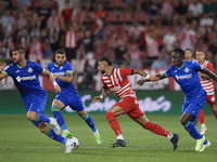 Taty Castellanos Centre-Forward of Girona and Argentina runs with the ball surrounded by Getafe players during the La Liga Santander match b...