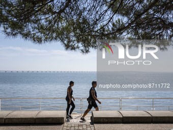 People are seen performing outdoor activities in the surroundings of the Tejo river promenade in Oriente. Lisbon, August 23, 2022. Portugal...