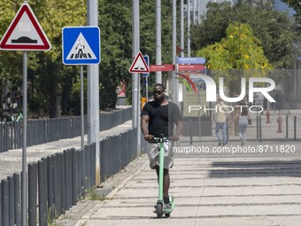 A man is seen riding a scooter in the area around the Tejo river promenade in Oriente. Lisbon August 23, 2022. Portugal recorded another wee...