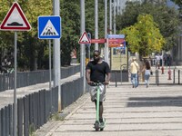 A man is seen riding a scooter in the area around the Tejo river promenade in Oriente. Lisbon August 23, 2022. Portugal recorded another wee...