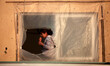 Palestinian girl look from the window of her family's home in the Shati refugee camp in Ga...