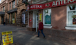 People walk past a currency exchange office in Kiev, on April 22, 2014. 