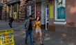 People walk past a currency exchange office in Kiev, Ukraine, on April 22, 2014. 