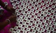 Woman worker  preparing  Diya (Earthen Lamp) for the Diwali festival  in the rural area of...
