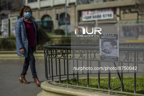 The photo of a detainee disappeared during Pinochet's civil-military dictatorship is placed in the street as a woman walks in Santiago de Ch...