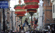 Locals carry a chariot of Lord Narayan across the streets of Hadigaun celebrating Lord Nar...