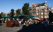 A view of the Mulatuli Statue and cafe tables in Amsterdam, Netherlands on September 1, 20...