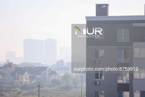 The construction sites of Kyiv outskirts are seen through the smoke from outside the city, in Kyiv, Ukraine, September 2, 2022.Kyiv was shro...
