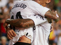 Samu Castillejo (L) of Valencia CF celebrates after scoring their side's third goal with his teammate Marcos Andre during the LaLiga Santand...