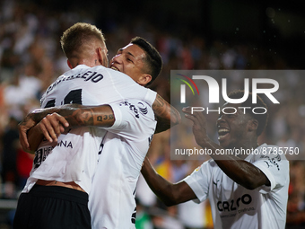 Samu Castillejo (L) of Valencia CF celebrates after scoring their side's third goal with his teammates Marcos Andre (C) and Yunus Musah duri...