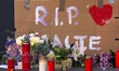 A sign of " RIP Malte" and several candles are seen during  the vigil for a young trans ma...