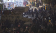 A military vehicle is pictured on a street-side as Shi'ite pilgrims walk along a street to...