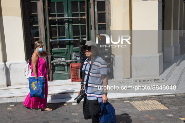 A tourist is wearing a hat at Monastiraki square in the center of Athens, Greece on September 14, 2022. 