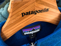 Patagonia logos are seen on a hanger and on a sweater in the store in Krakow, Poland on September 16, 2022. (