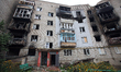 IZIUM, UKRAINE - SEPTEMBER 15, 2022 - A burnt-out apartment building destroyed as a result...