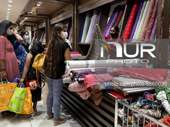 Customers look at cloth to be made into ladies churidar suits at a textile shop in Thiruvananthapuram, Kerala, India, on May 22, 2022. (