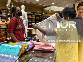 Woman looking at churidar suits at a textile shop in Thiruvananthapuram, Kerala, India, on May 22, 2022. (