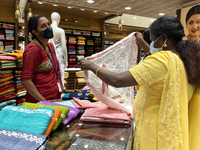 Woman looking at churidar suits at a textile shop in Thiruvananthapuram, Kerala, India, on May 22, 2022. (