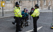 LONDON, UNITED KINGDOM - SEPTEMBER 17, 2022: A woman in a wheelchair takes a picture of he...