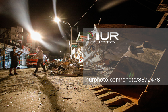 Reporters outside the wreckage of a collapsed residential building after a magnitude 6.8 earthquake strikes Taiwan, in Yuli, Hualien, Taiwan...