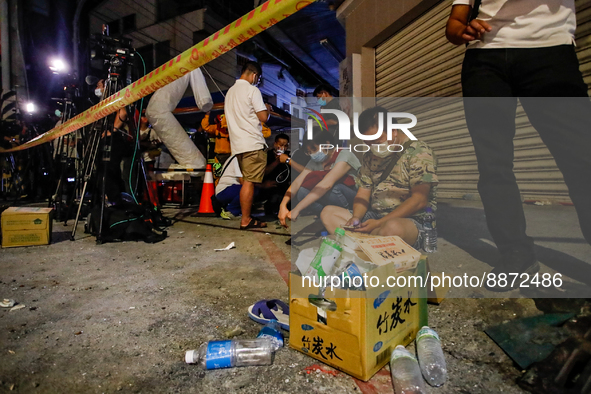 Exhausted residents waiting outside the wreckage of a collapsed residential building after a magnitude 6.8 earthquake strikes Taiwan, in Yul...