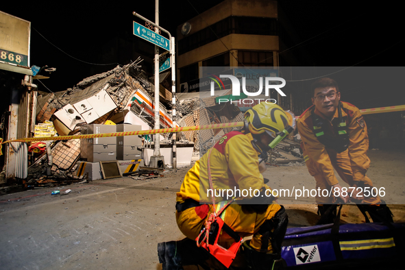 Rescuers organising equipment  outside the wreckage of a collapsed residential building after a magnitude 6.8 earthquake strikes Taiwan, in...