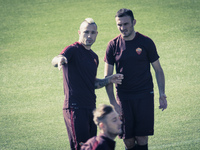 Nainggolan (L) and Torosidis (R), AS Roma's players, warm up during a training session, on the eve of the team's Champions League football m...