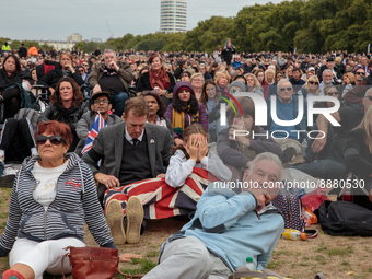 Members of the public watching the funeral broadcast of Queen Elizabeth on screen in Hyde Park on September 19, 2022, in London, England. Qu...